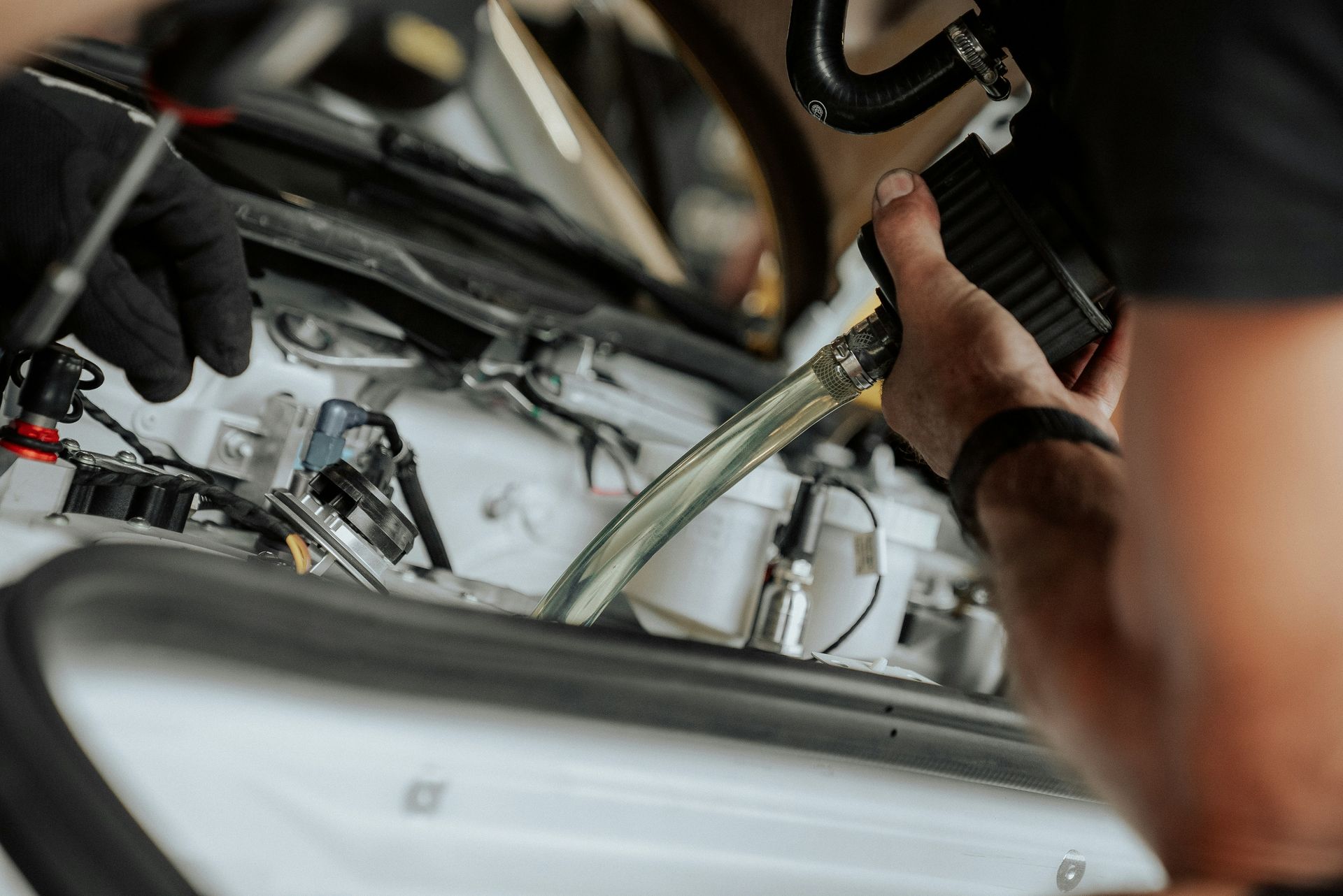 Mechanic works on a car's engine components